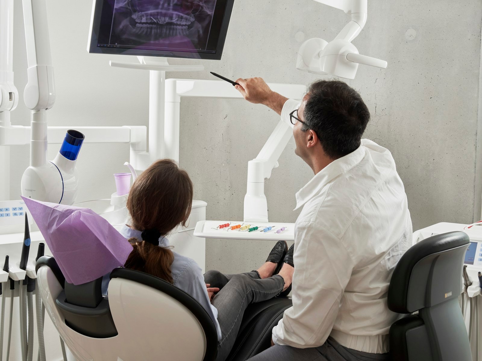 Dentist at Demo Dental Studio reviewing a dental X-ray with a patient